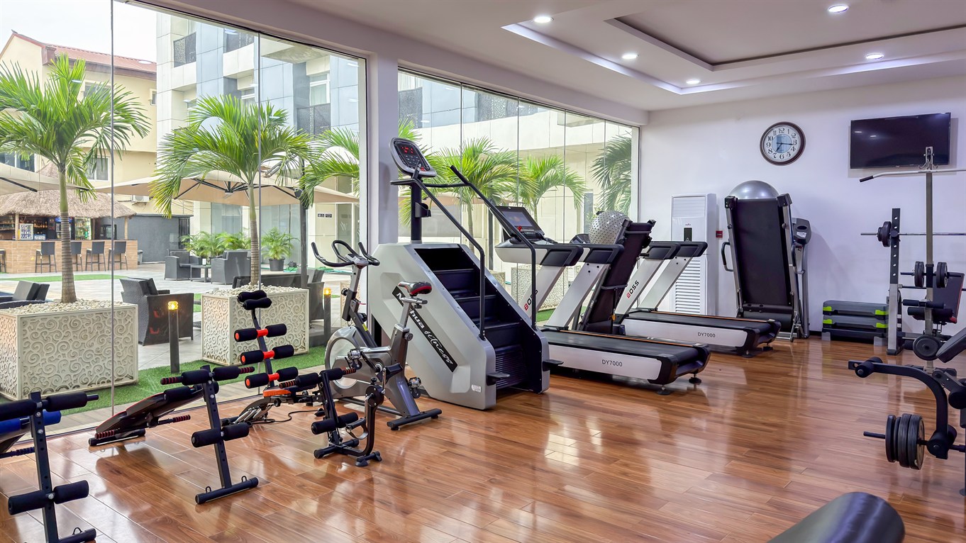 The gym, with cardio equipment facing tall windows