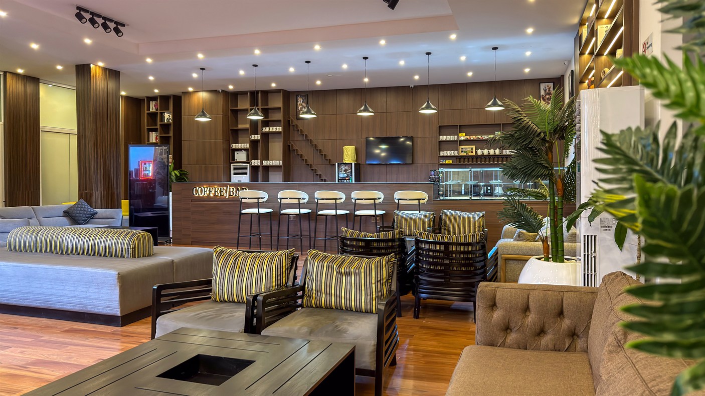 A low-lit lounge with a bar and deep seating