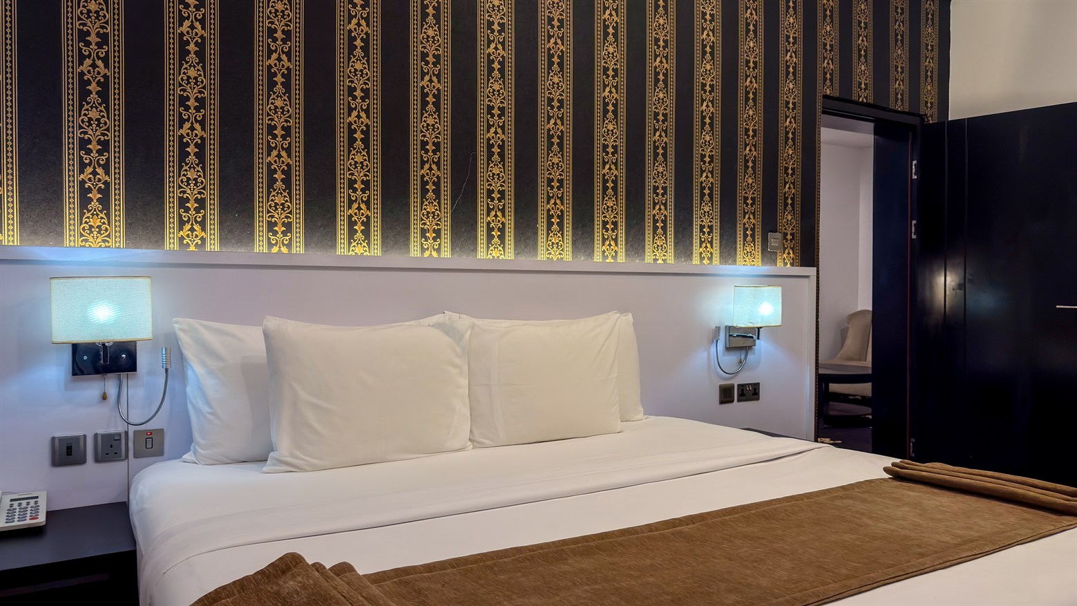A one-bedroom suite bedroom with cream linen